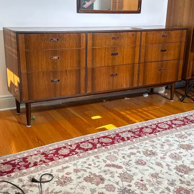 MAURICE VILLENCY MID-CENTURY MODERN ROSEWOOD NINE-DRAWER DRESSER
This nine-drawer dresser features rosewood veneers and a rectangular...
