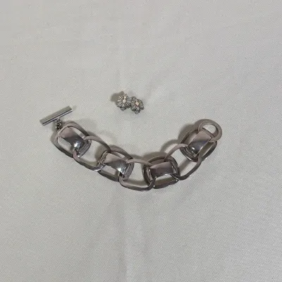 GEORG JENSEN STERLING SILVER BRACELET AND PAT BEDONI 14K GOLD AND STERLING EARRINGS
This lot features a sterling silver link bracelet...