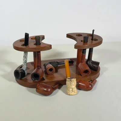(7pc) VINTAGE WOODEN EIGHT-PIPE RACK AND ASSORTED BRIAR AND MEERSCHAUM PIPES
An oval wooden pipe rack with two crescent-shaped upper...