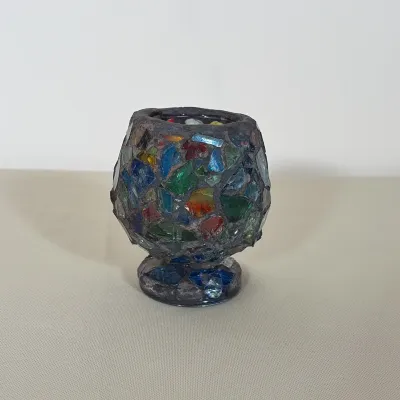 MOSAIC GLASS VOTIVE CANDLE HOLDER
This decorative candle holder features a bulbous body and a pedestal base. Multi-colored glass shards...