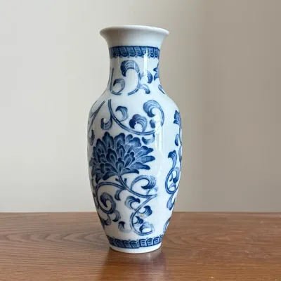 CHINESE BLUE AND WHITE CRACKLE GLAZE PORCELAIN VASE
A blue and white porcelain vase featuring an all-over crackle glaze and a flared rim....