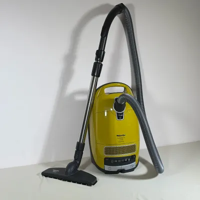 MIELE COMPLETE C3 CALIMA POWERLINE CANISTER VACUUM WITH PARQUET TWISTER
Curry-colored canister vacuum features a silver-tone honeycomb...