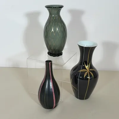 GROUP OF THREE MID-CENTURY MODERN VASES INCLUDING MURANO STYLE GLASS AND GDR PORCELAIN
This collection includes a smoky green glass vase...