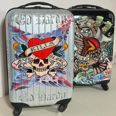 PAIR OF ED HARDY BY CHRISTIAN AUDIGIER ROLLING HARDSHELL SUITCASES
This set includes two hardshell suitcases featuring tattoo-inspired...