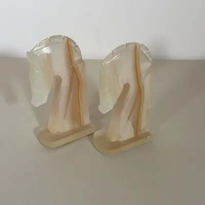 PAIR OF ART DECO STYLE CARVED ONYX HORSE HEAD BOOKENDS
A pair of bookends carved from banded onyx in the form of stylized horse heads....