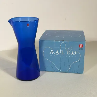 ALVAR AALTO AND KAJ FRANCK FOR IITTALA COBALT BLUE GLASS VASE AND PITCHER
A cobalt blue glass vase and pitcher set produced by Iittala....