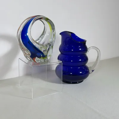 (2pc) COBALT BLUE GLASS BEEHIVE PITCHER AND MULTI-COLOR ART GLASS BASKET
The cobalt blue glass pitcher features a three-tiered beehive...