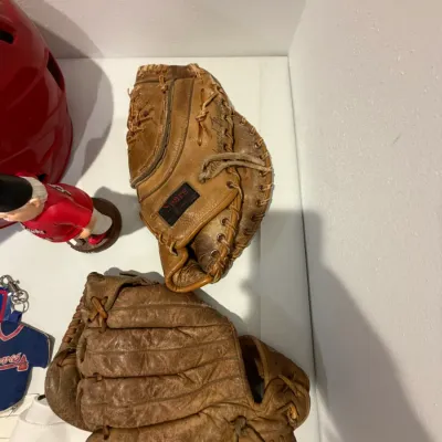 Sale Photo Thumbnail #211: Signed RedHawks Batting Helmet, Twins Homer Hanky (x4), 2 right handed baseball mitts, RedHawks gnome, Atlanta Braves license plate