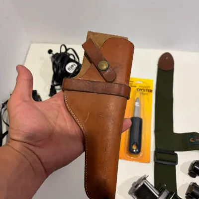 Sale Photo Thumbnail #291: Putter return, leather gun holster, suspenders, knife, sight mounts, hand radio, fishing reel