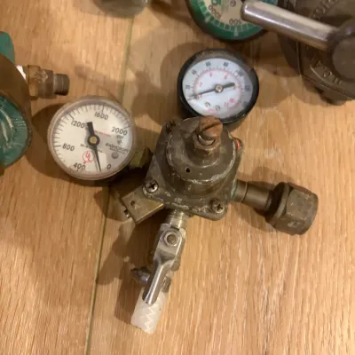 Sale Photo Thumbnail #304: 3 regulators, gear shift knob, small vise