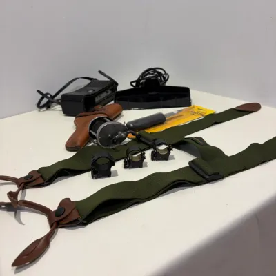 Sale Photo Thumbnail #288: Putter return, leather gun holster, suspenders, knife, sight mounts, hand radio, fishing reel
