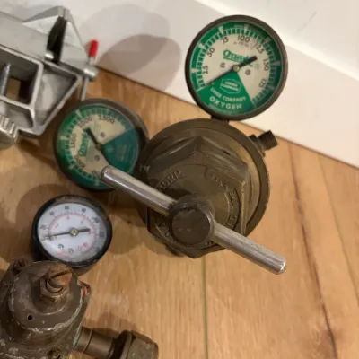 Sale Photo Thumbnail #305: 3 regulators, gear shift knob, small vise
