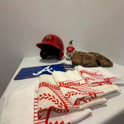 Sale Photo Thumbnail #210: Signed RedHawks Batting Helmet, Twins Homer Hanky (x4), 2 right handed baseball mitts, RedHawks gnome, Atlanta Braves license plate