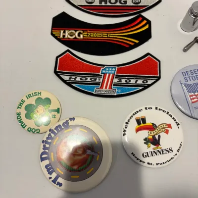 Sale Photo Thumbnail #244: Lot of various patches, pins, hide scraper, lighter, leather pouch