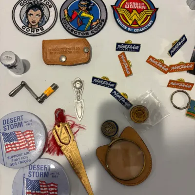 Sale Photo Thumbnail #246: Lot of various patches, pins, hide scraper, lighter, leather pouch