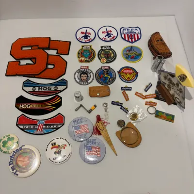Sale Photo Thumbnail #242: Lot of various patches, pins, hide scraper, lighter, leather pouch