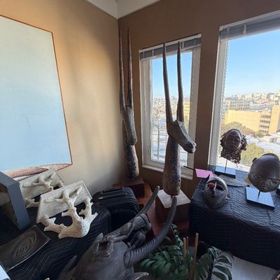 Rare pair of antique African Antelope Masks museum mounted along with Billy Baldwin style wall bracket shelves 