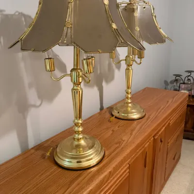 Vintage brass table lamps featuring smoked glass panel shades and triple candle-style sockets.