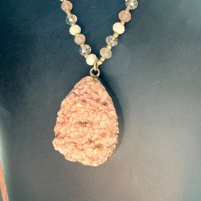 pink or peach druzy crystal pendant necklace with a beaded chain and a teardrop-shaped stone