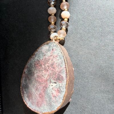 pink or peach druzy crystal pendant necklace with a beaded chain and a teardrop-shaped stone