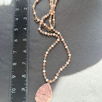 pink or peach druzy crystal pendant necklace with a beaded chain and a teardrop-shaped stone