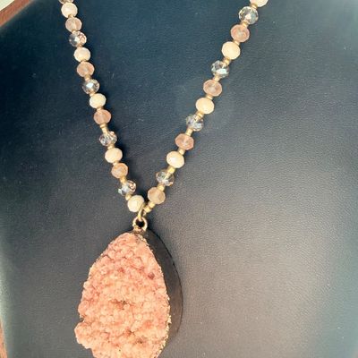 pink or peach druzy crystal pendant necklace with a beaded chain and a teardrop-shaped stone