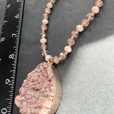 pink or peach druzy crystal pendant necklace with a beaded chain and a teardrop-shaped stone