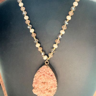 pink or peach druzy crystal pendant necklace with a beaded chain and a teardrop-shaped stone