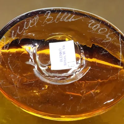 Sale Photo Thumbnail #2: Base of an Blenko decanter, featuring an etched signature of Richard Blenko dated 2005 and an original paper label from Milton, West Virginia.