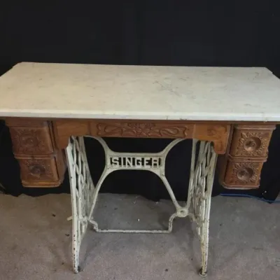 3 - Marble Top Singer Sewing Table
This table features a marble top set on a vintage Singer sewing machine base. It measures 42 inches...