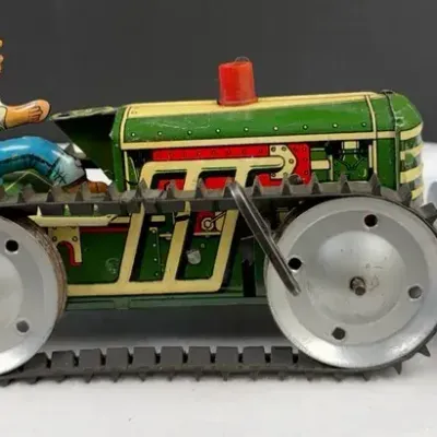 Vintage Marx Tin Lithographed Windup “Power Snap Caterpillar Climbing Tractor” featuring a green bod