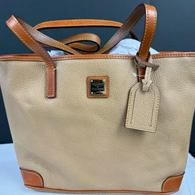  Dooney & Bourke Charleston Shopper tote with British tan trim and a front logo plaque