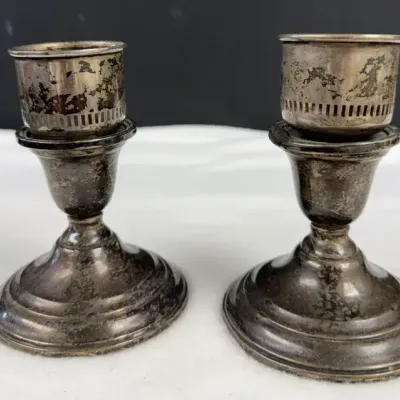 Vintage weighted sterling silver candlestick holders featuring flared round bases and removable slot