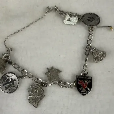 Vintage sterling silver link charm bracelet decorated with various souvenir and themed dangling char