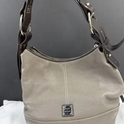 Dooney & Bourke Pebble Grain Hobo Handbag in elephant gray, featuring a contrasting dark brown shoul