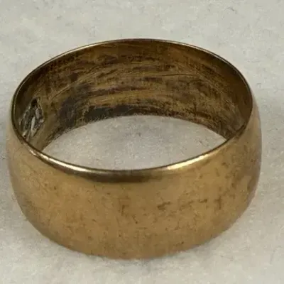 Vintage wide dome gold wedding band stamped with a 10K hallmark