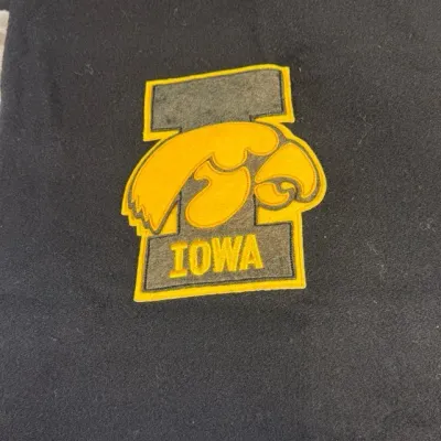 Vintage black wool Amana Woolen Mills blanket throw featuring an embroidered Iowa Hawkeyes logo patc