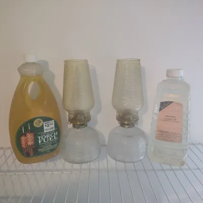 Two Oil Lamps And Bottles Of Citronella 