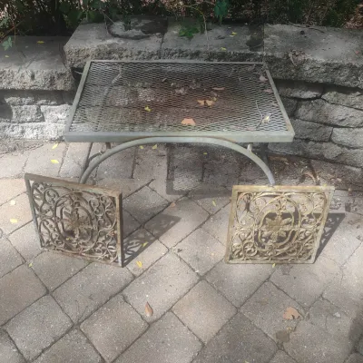 2 Cast Iron Architectural Grates And A Metal Table