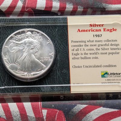 Sale Photo Thumbnail #412: 1987 American Silver Eagle, .999 Fine Silver 1 Troy Oz - Choice Uncirculated in Littleton Coin Company Holder