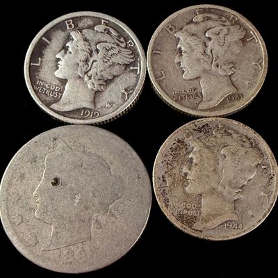 A Collection of Four US Coins Including Mercury Silver Dimes and an 1894 Liberty Head Nickel