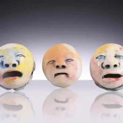 Sale Photo Thumbnail #129: Trio of double sided face/ bird head art pottery sculptures #2