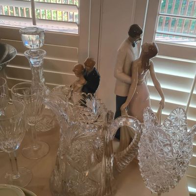 Cut glass pitcher, crystal stemware, porcelain couple figurine