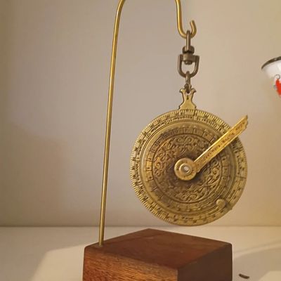 Brass astrolabe on wood display stand