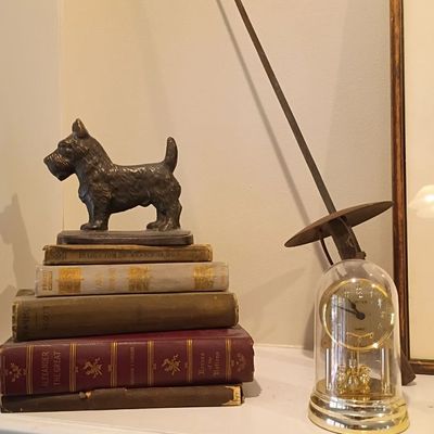 Cast metal Scottie dog figure, anniversary clock, vintage books
