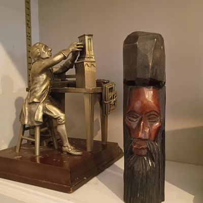 Metal printer figurine, carved wood face sculpture