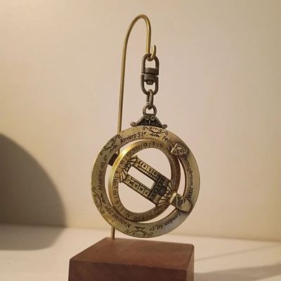 Brass ring sundial on wood display stand
