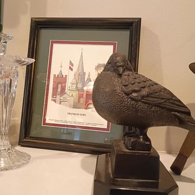 Bronze bird sculpture on marble base, framed architectural print