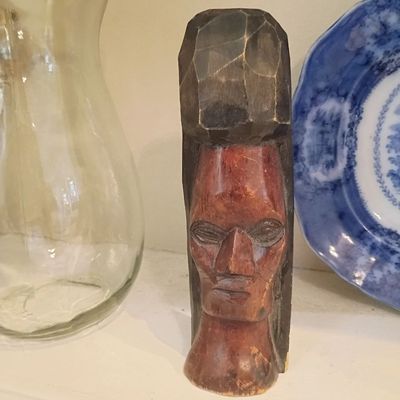Carved wood head sculpture, glass vase