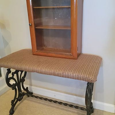 Wood wall curio cabinet, cast iron base upholstered bench
